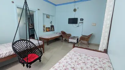 a room with a swing and a living room at Delight Homestays Coorg in Kushālnagar