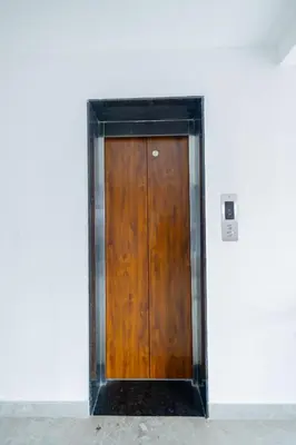 a wooden door in the side of a building at HOTEL VARDHA Inn in Bhavāni