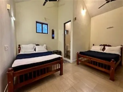 a bedroom with two beds in a room at The Wild Farms By Gwestai in Masinagudi