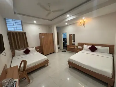 a bedroom with two beds in a room at Seema Palace Inn 1 km from Railwaystaion in Mysore