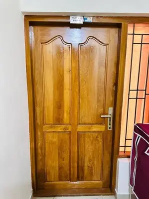 a wooden door with a sign on top of it at Soorya Madhavam Apartment Guruvayur - 200 m from temple walkable in Guruvāyūr
