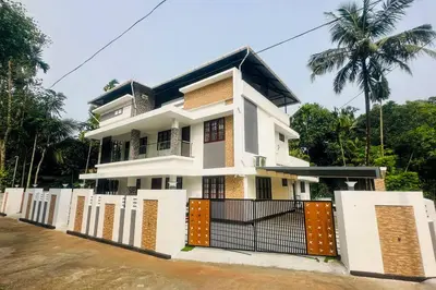 a house with a gate in front of it at Elegant RiverView Villa in Cochin