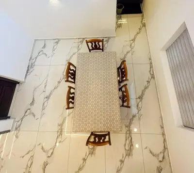 a large light fixture hanging from the ceiling in a bathroom at Elegant RiverView Villa in Cochin