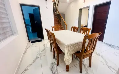 a dining room with a table and chairs at Elegant RiverView Villa in Cochin