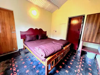 a bedroom with a large bed in a room at VERMONT HOMe STAY in Ooty