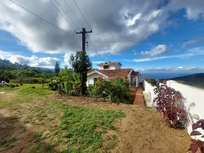 a house on the side of a road with a fence at VERMONT HOMe STAY in Ooty