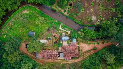 an aerial view of a large estate with trees at River view cottage in Vythiri