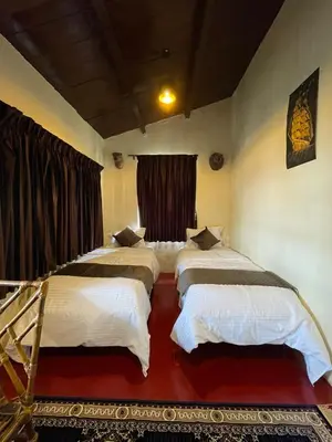 a bedroom with three beds in a room at Sandy Holiday Home 5 Bhk in Ooty