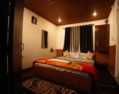 a small bedroom with a bed with a window at The Green Casa By Green leaves -Families Only in Ooty