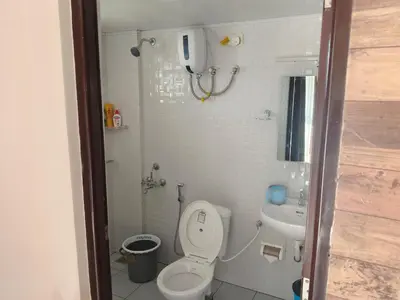 a small bathroom with a toilet and a sink at Sancta Maria Airport Hotel in Cochin