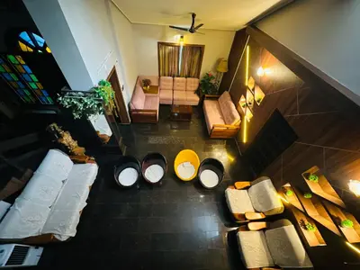 an overhead view of a living room with couches and chairs at The Mallika Holidays in Mananthavady