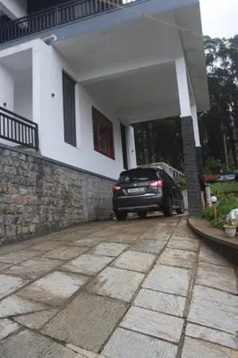 a car parked in front of a house at Airy Homestay Ooty by Lexstays in Ooty