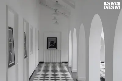 a hallway with a black and white checkered floor at Stayvista at Mudra Manor 4BR - Coffee Estate Comp Breakfast Big Heated Pool in Madikeri