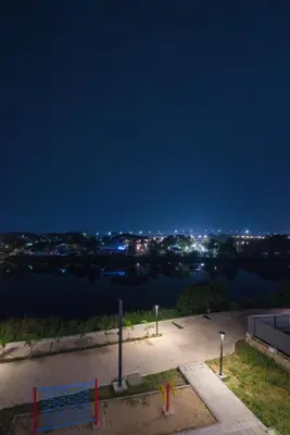a view of a river at night at AAFIYA LAKEVIEW APARTMENTS in Coimbatore