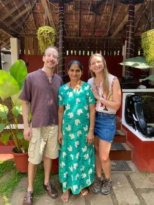 a group of three people posing for a picture at Dove cottage in Cherai Beach