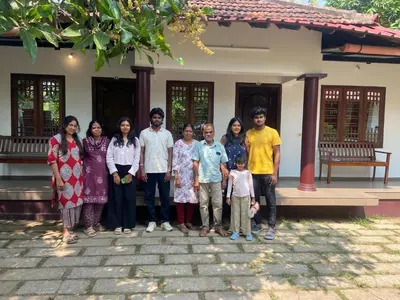 a group of people standing in front of a house at Dove cottage in Cherai Beach
