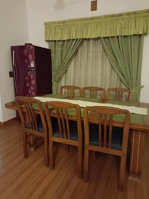 a dining room table with chairs and a table and a table and chairsktop at Raaga on the Beach in Kannur