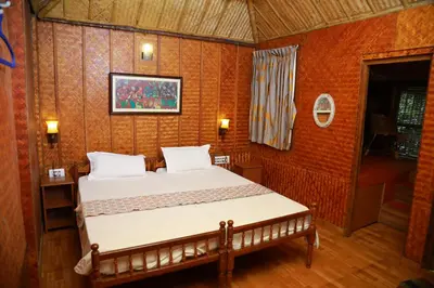 a bedroom with a bed in a room with orange walls at Sajeev Home Stay in Cherai Beach