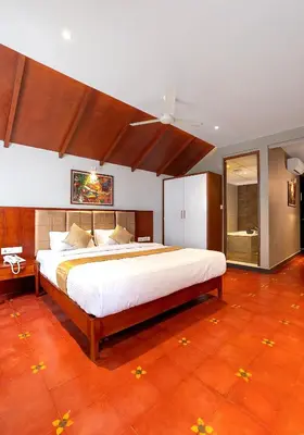 a bedroom with a large bed with a ceiling at Palcastle Regency in Palakkad