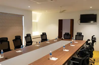 a conference room with a long table and chairs at Palcastle Regency in Palakkad