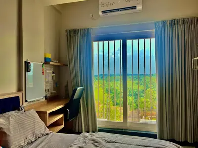 a bedroom with a bed and a large window at Green Horizon, Luxury & Nature at Kothamangalam in Kotamangalam