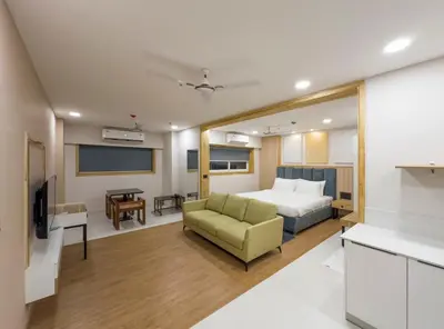 a hotel room with a bed and a couch at The Habitat Suites-Walkable distance to Guruvayoor temple in Guruvāyūr