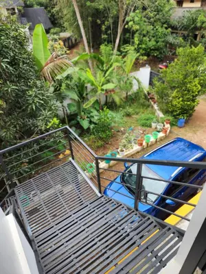 a metal bed with a pool in a garden at Olive Homestay 1bhk Diamond Ernakulam in Alwaye