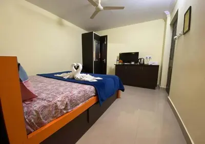 a bedroom with a bed with a towel on it at Joys Stay in Trichūr