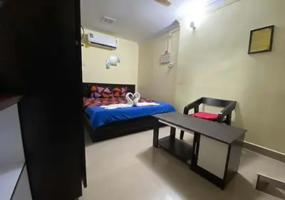 a small room with a bed and a table at Joys Stay in Trichūr