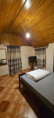 a bedroom with a bed and a piano in it at Moksha The blissful escape in Kaniyāmbetta