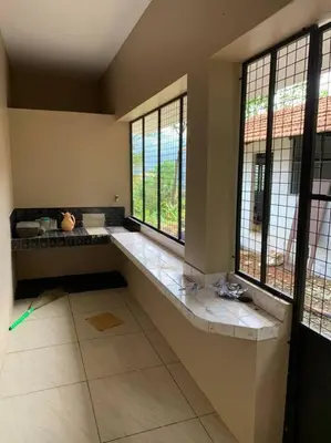 a large room with two windows and a large at Maskan Home Stay in Kakkadampoyil