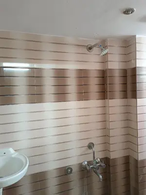 a bathroom with a sink and a shower at Royal Comforts in Mysore