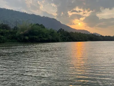 a view of a body of water with a sunset at Coconut Valley in Neriyamangalam