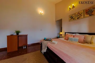 a bedroom with a large bed and a dresser in it at EKOSTAY - Moonlight Villa in Kodaikānāl