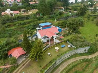 a large house with a red roof on a hill at EKOSTAY - Moonlight Villa in Kodaikānāl
