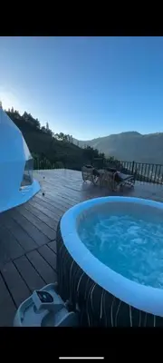 a large hot tub sitting on a wooden deck at Divercity Luxury Glamp in Kodaikānāl