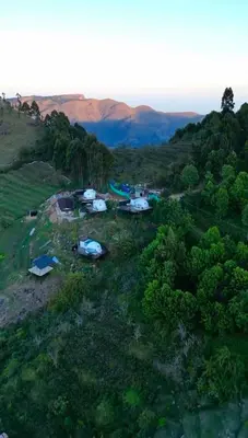 an aerial view of a group of tents on a hill at Divercity Luxury Glamp in Kodaikānāl