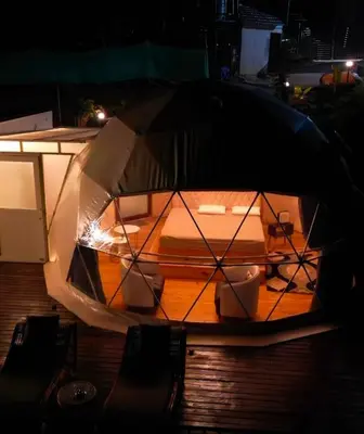 a close up of a boat in the water at night at Divercity Luxury Glamp in Kodaikānāl