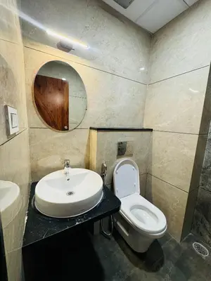 a bathroom with a sink and a toilet at S K Legacy Hotel in Mysore