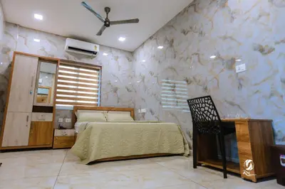 a bedroom with a bed and a stone wall at AN REGENCY in Edappāl