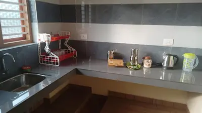a kitchen with a sink and a counter top at Souparnika Lakeview Homestay LLP in Wayanad