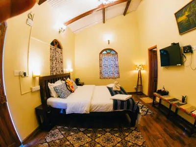 a bedroom with a large bed in a room at LA Address Retreat - The Heritage Homestay in Ooty