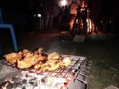 a group of chickens cooking on a grill at Samz estate stay 2BHK in Madikeri