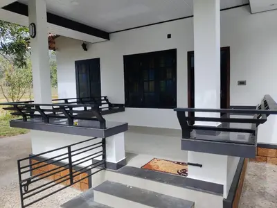 a row of benches on the side of a building at Woodside Haven in Chekadi