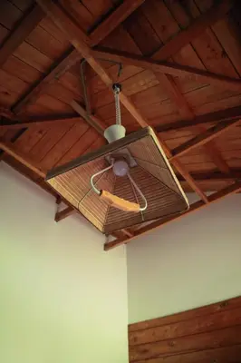 a fan hanging from the ceiling of a room at Royal Wooden villa in Mananthavady