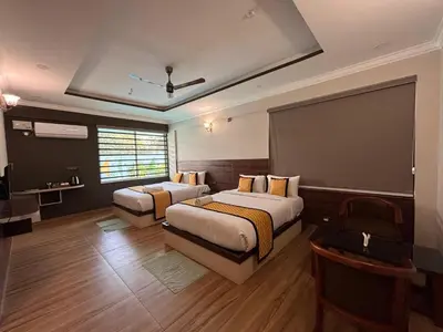 a hotel room with two beds and a chalkboard at Coorg Le Embera in Virajpet