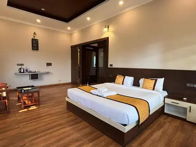 a bedroom with a large bed in a room at Coorg Le Embera in Virajpet