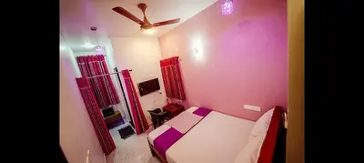 a small bedroom with a bed and a ceiling fan at ARUL Residency in Mettuppālaiyam