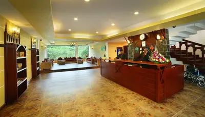 a large lobby with a waiting room and a salon at Hotel C7 Munnar in Munnar
