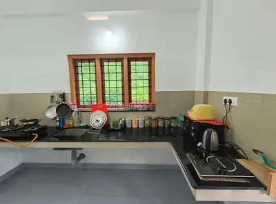 a kitchen with a sink and a counter top at GREEN FIELDS Apartments in Mananthavady
